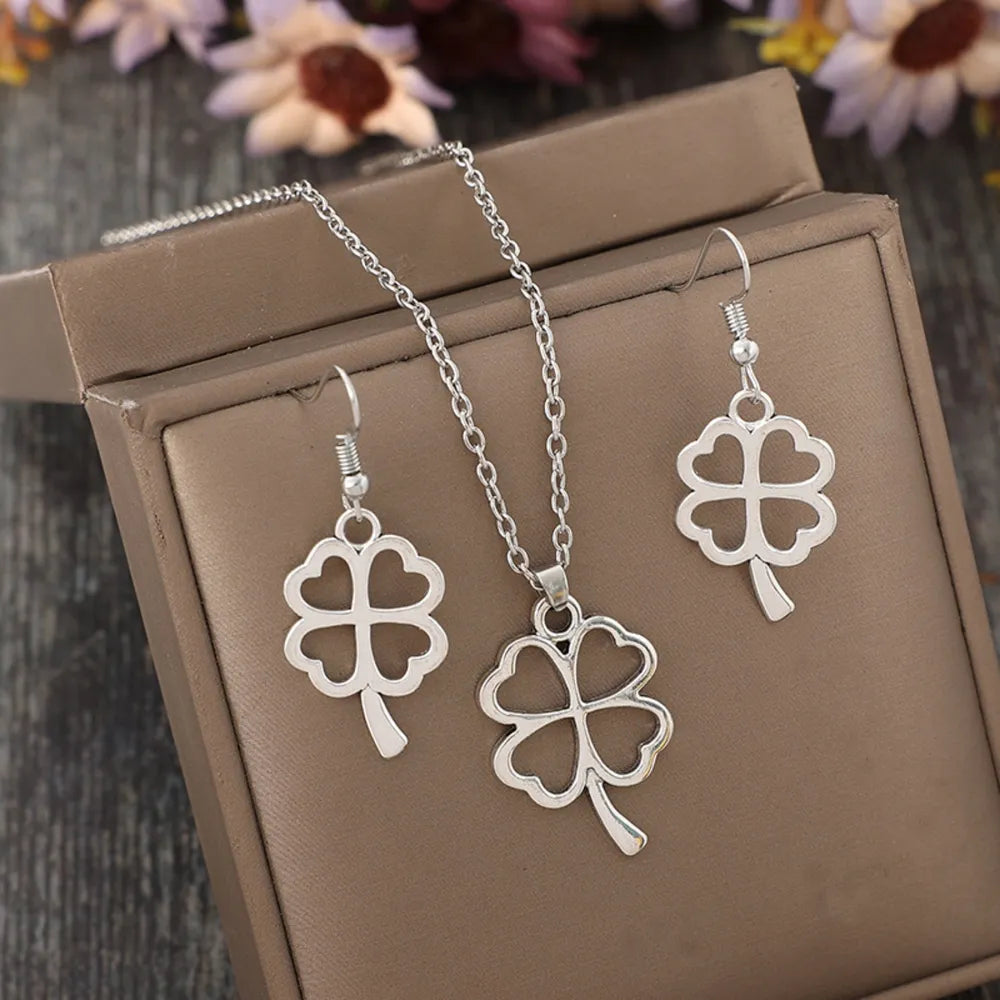 Lucky clover jewelry set featuring a necklace and matching earrings displayed in a gift box.